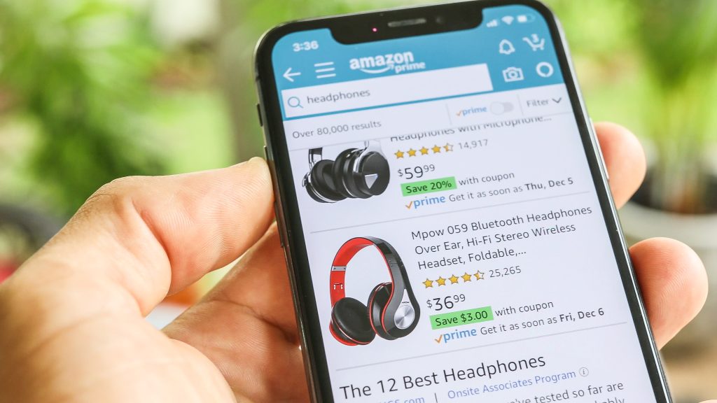 Man searching Headphones on Amazon app with Mobile Smart iPhone