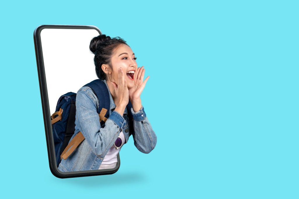 A woman with her mouth open holds a phone, symbolizing engagement in digital marketing strategies and agency work.