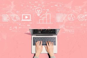 Hands typing on a laptop with digital icons representing ideas, growth, and connectivity on a pink background.