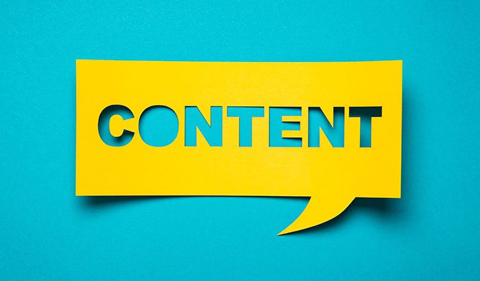 Stock photo of content concept on blue background with speech bubble. Perfect for content marketing, services, and SEO