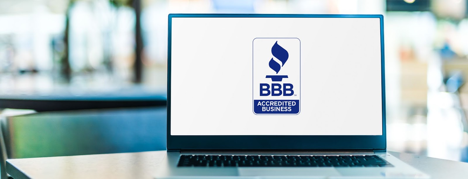 Close-up of a laptop with the bbb logo, highlighting the brand's focus on online services and digital communication.